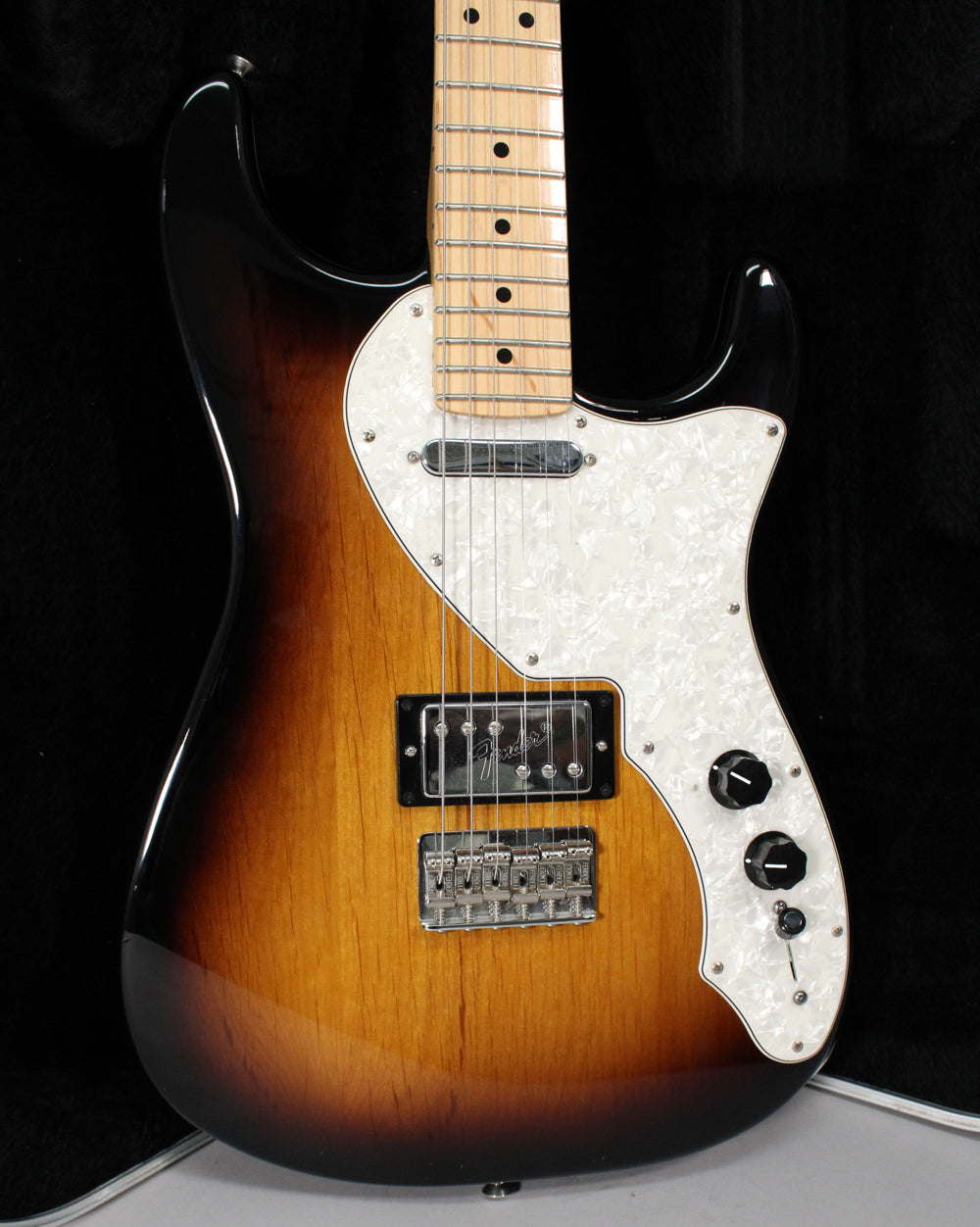 Full-body view of a glossy 2-color sunburst electric guitar with a pearloid pickguard, a humbucker, and two black control knobs.