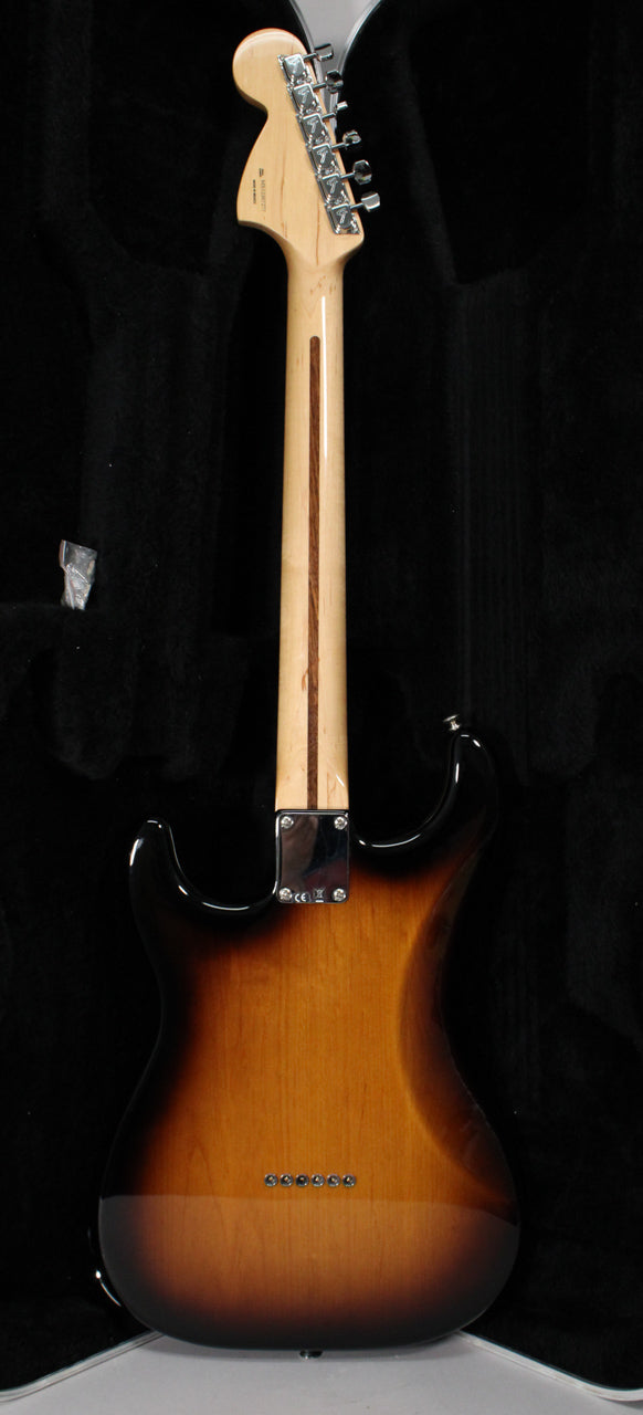 Rear view of a sunburst Stratocaster, showing the maple neck with a dark stripe, chrome tuners, and string-through-body ferrules.