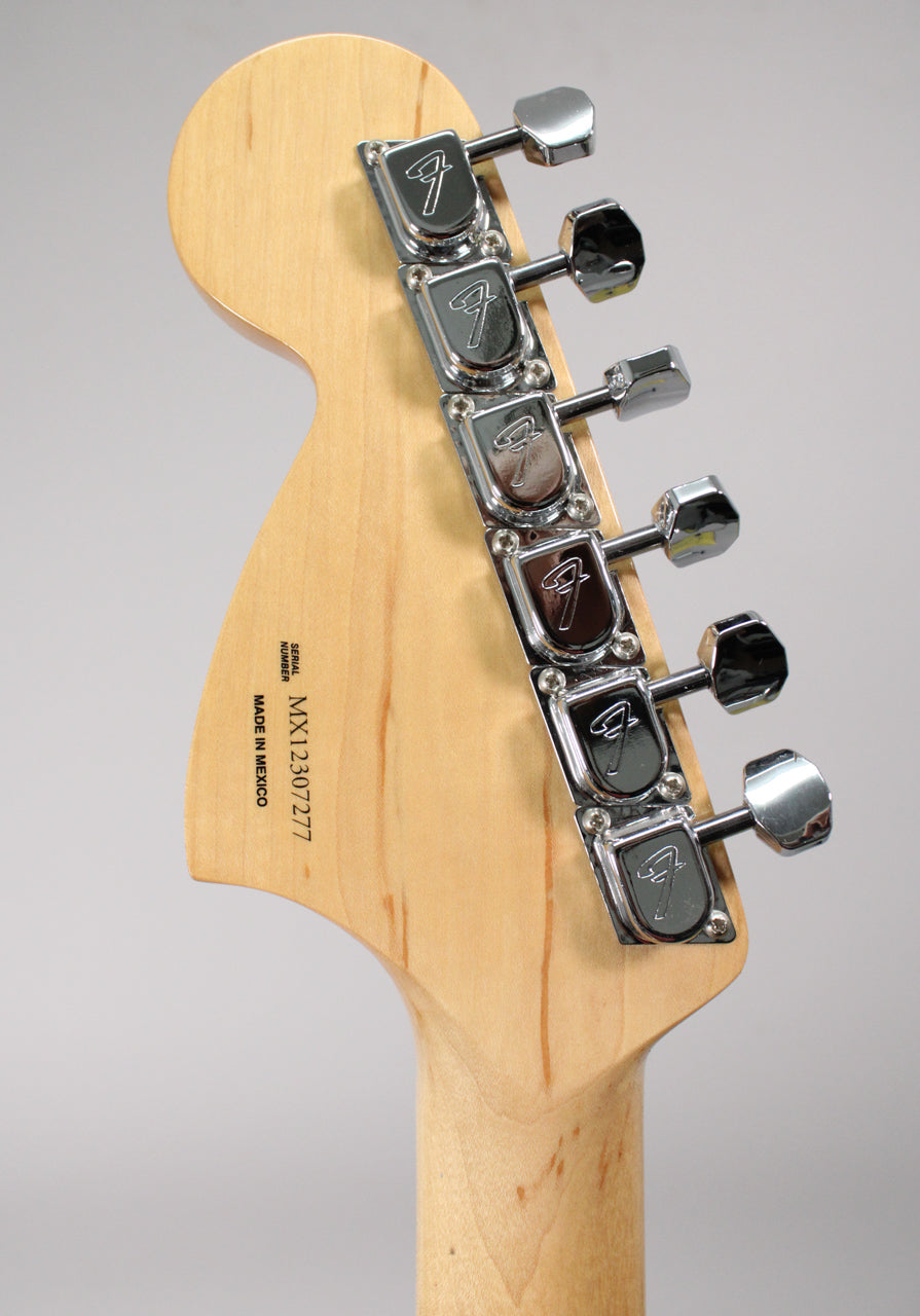 Rear view of the guitar's natural maple headstock and neck, showing six chrome tuners with F-stamped covers and light wear.