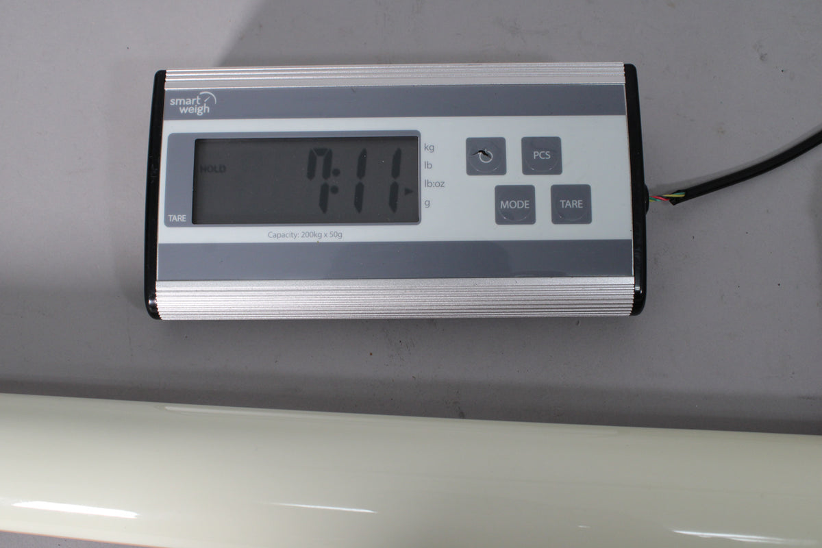 A digital scale displays "7.11" lbs, with a classic white guitar body partially visible below.