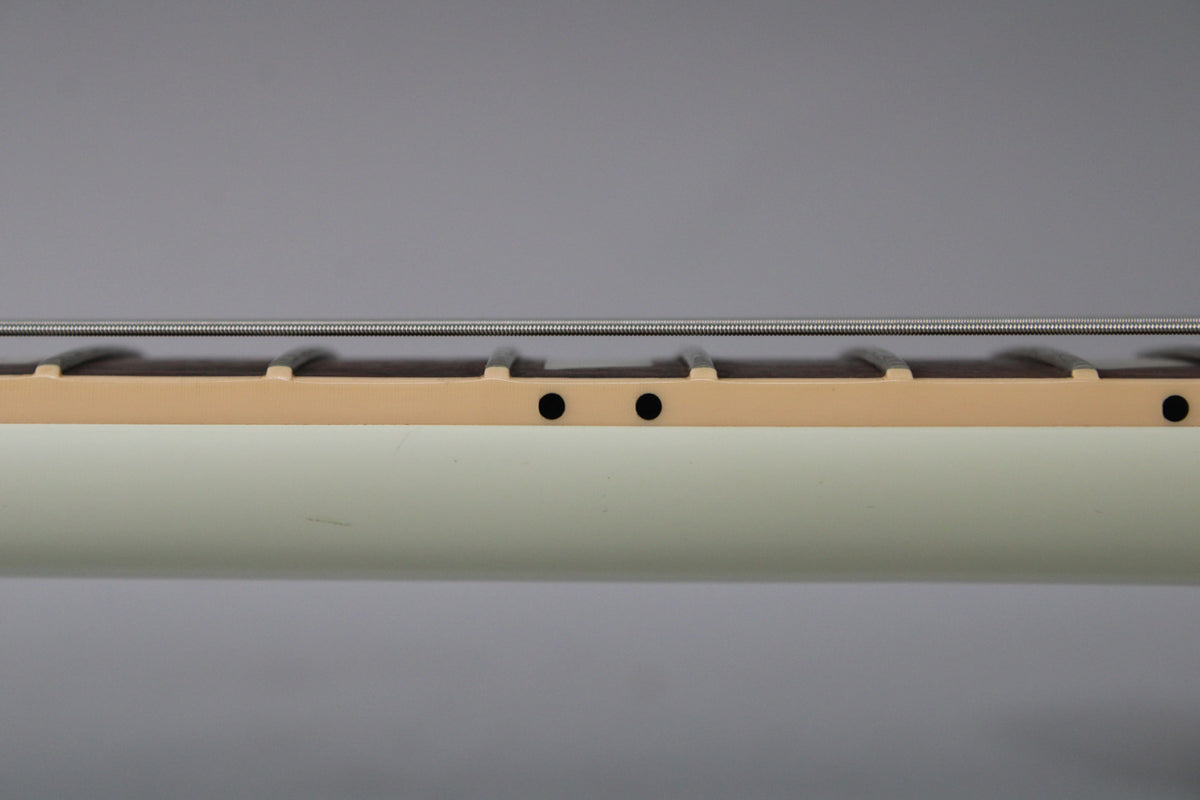 Close-up of the guitar's neck, showing the cream-bound rosewood fretboard with two black dot markers and a few minor scuffs on the white finish.