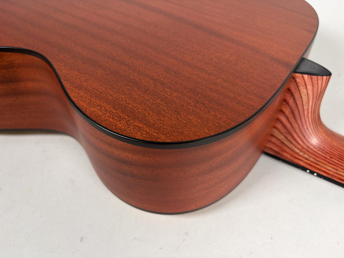 Close-up of the guitar's lower bout and heel, showing the reddish-brown satin finish and distinct wood grain on the neck.