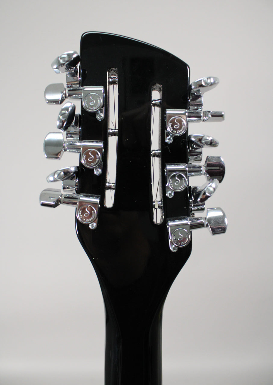 Rear view of the glossy black headstock and neck, showing 12 chrome tuners with "S" logos, 6 on each side.