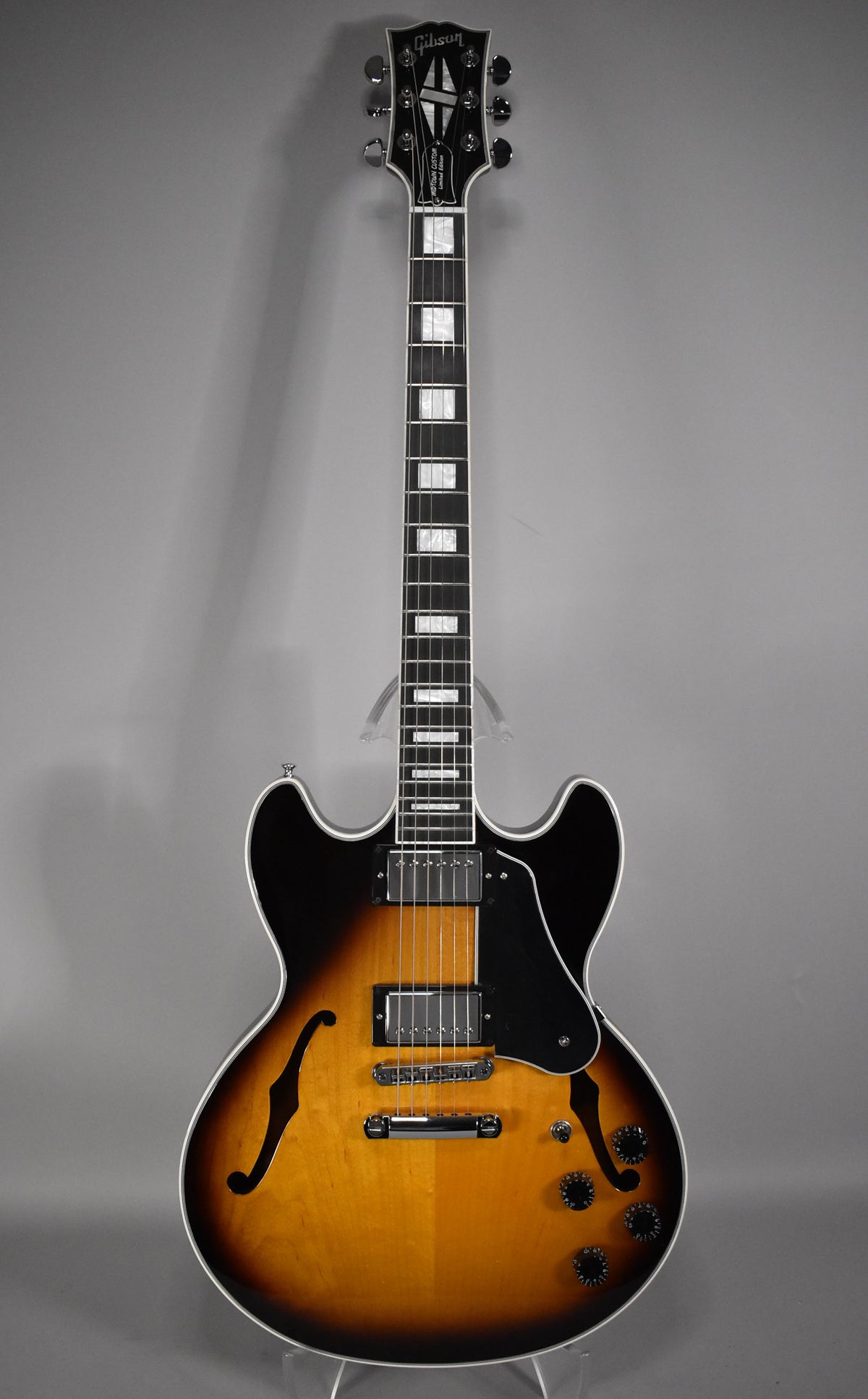 Full front view of a semi-hollow guitar with a vintage sunburst finish, f-holes, two humbuckers, and four black control knobs.