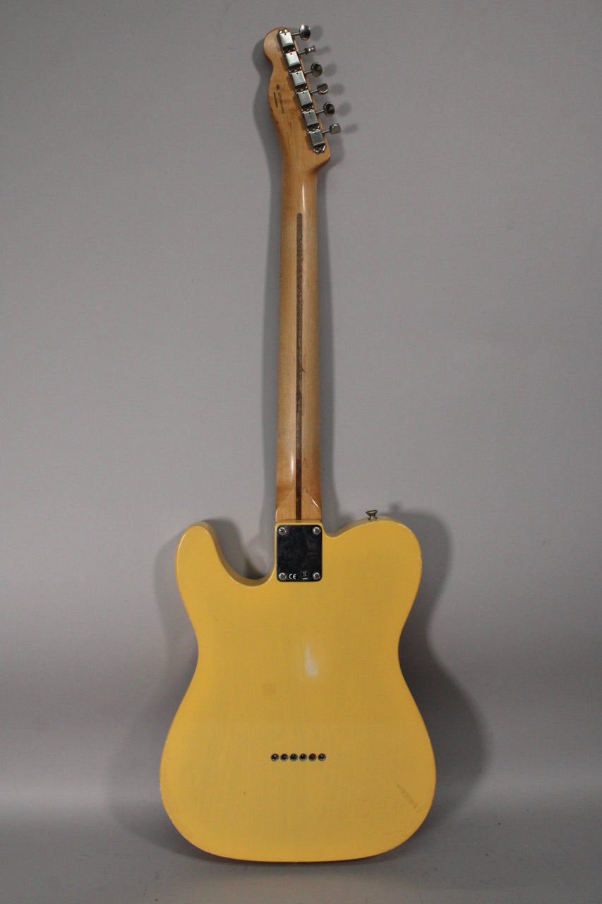 Full rear view of a blonde Telecaster with a maple neck, string-through-body bridge, and visible finish wear and checking.