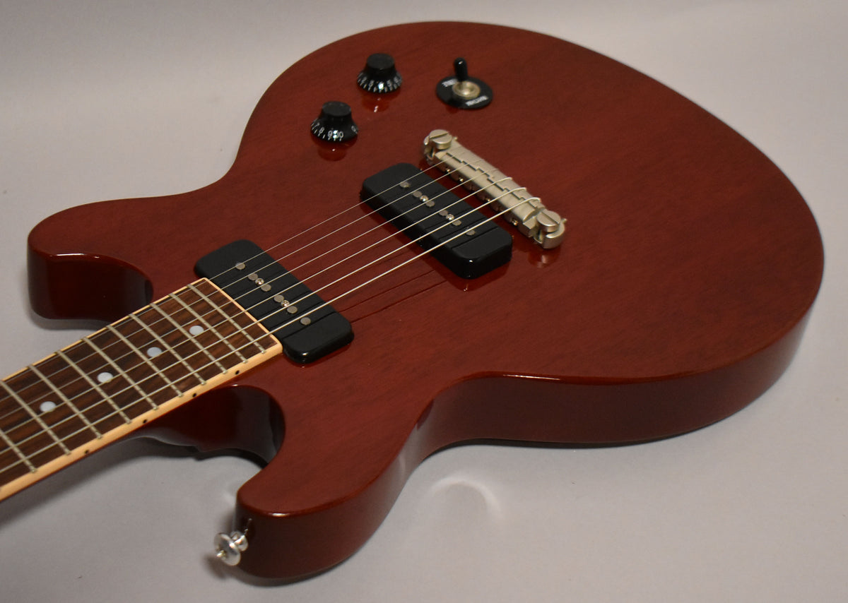 Cherry red electric guitar body with two black P90 pickups, a tune-o-matic bridge, two volume/tone knobs, and a three-way toggle switch.