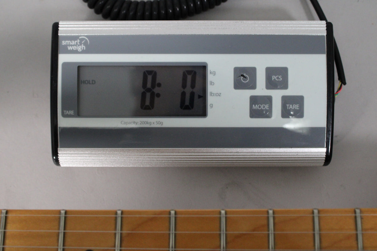 A Smart Weigh digital scale displays "8:0" with a maple fretboard and frets visible below.