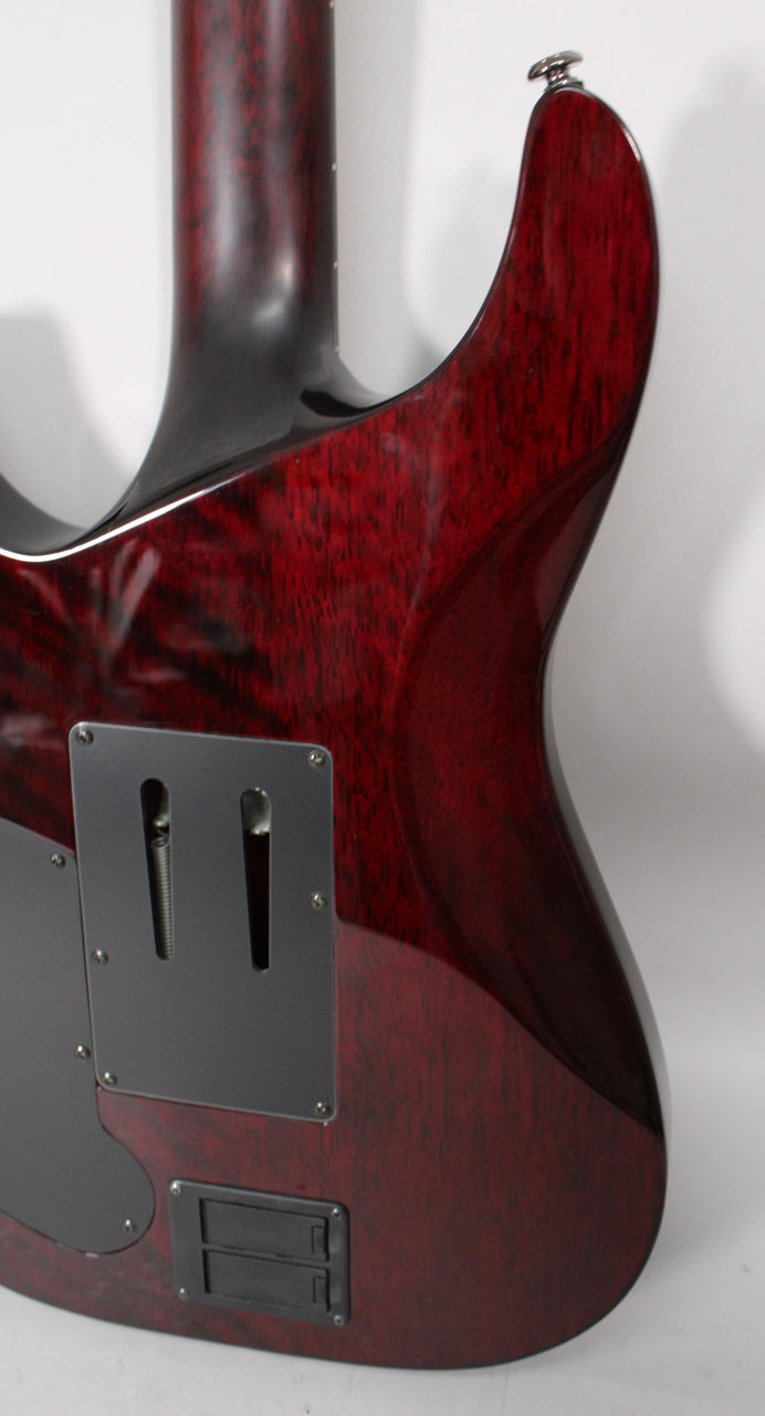 Rear view of the guitar's lower body and neck heel, showing the dark cherry burst finish, black tremolo cavity cover, and battery box.