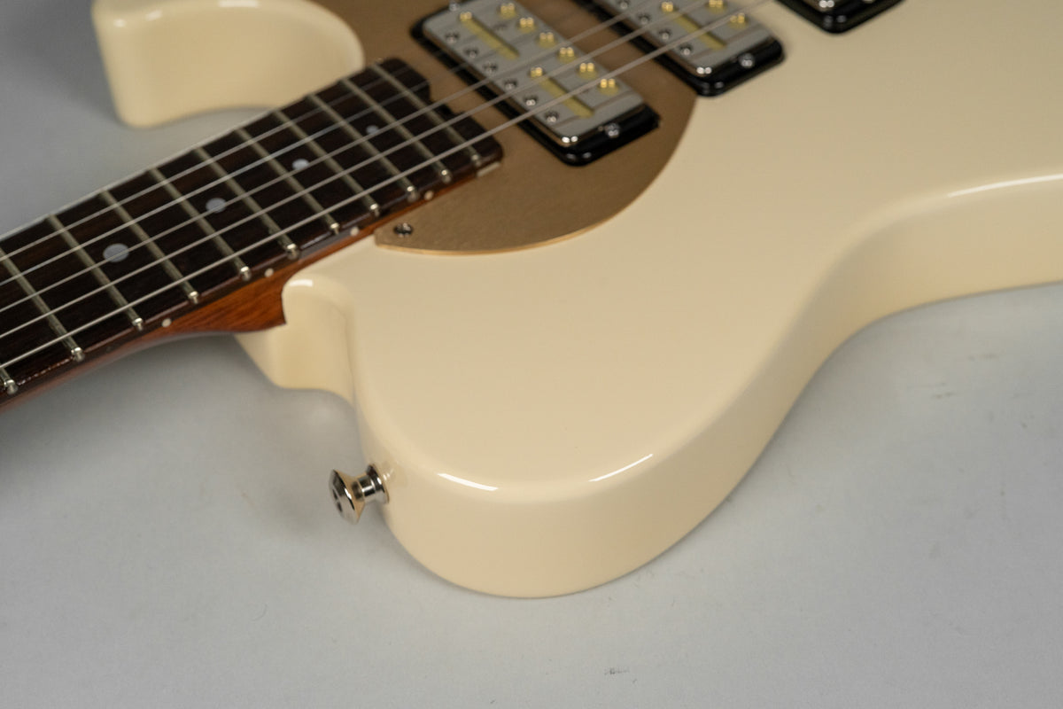 The antique white guitar body, with a gold pickguard and Lollar Gold Foil pickups, is shown from the lower bout and neck joint.
