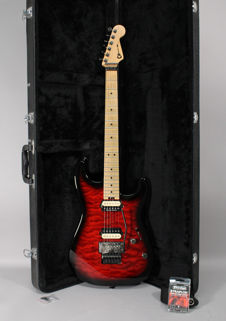 Full-length view of a transparent red burst electric guitar with a maple fretboard, black hardware, and a Floyd Rose tremolo system.