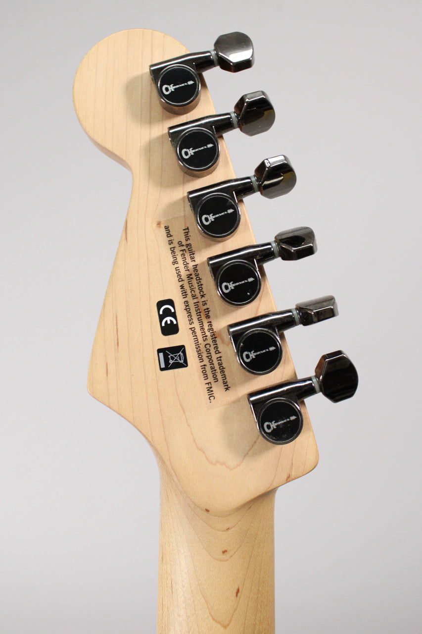 The back of a light wood headstock and neck, angled right, with six black tuners in a 6-in-line configuration.