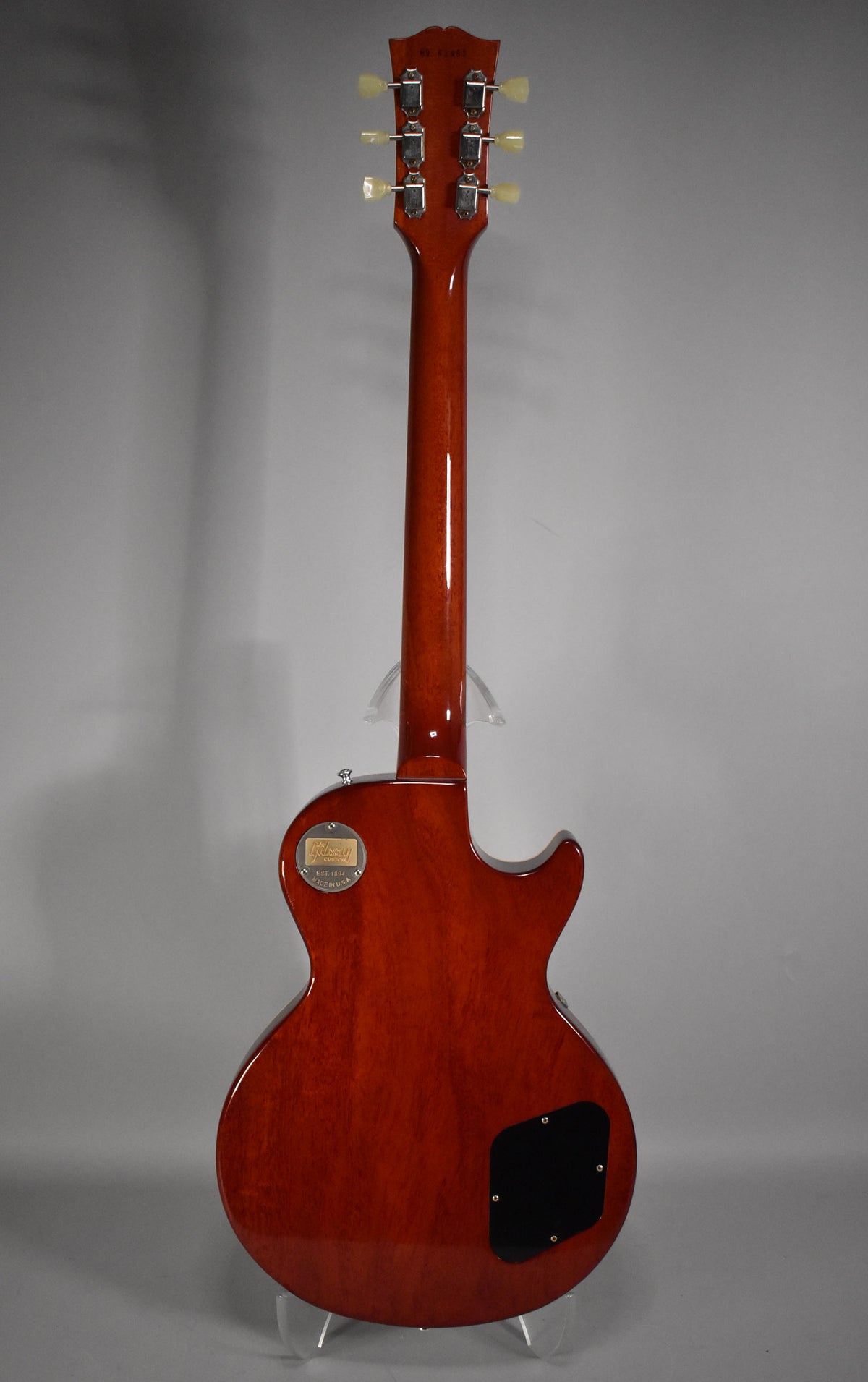 Full rear view of a glossy faded tobacco Les Paul, showing the headstock with six cream tuners and a black control cavity cover.