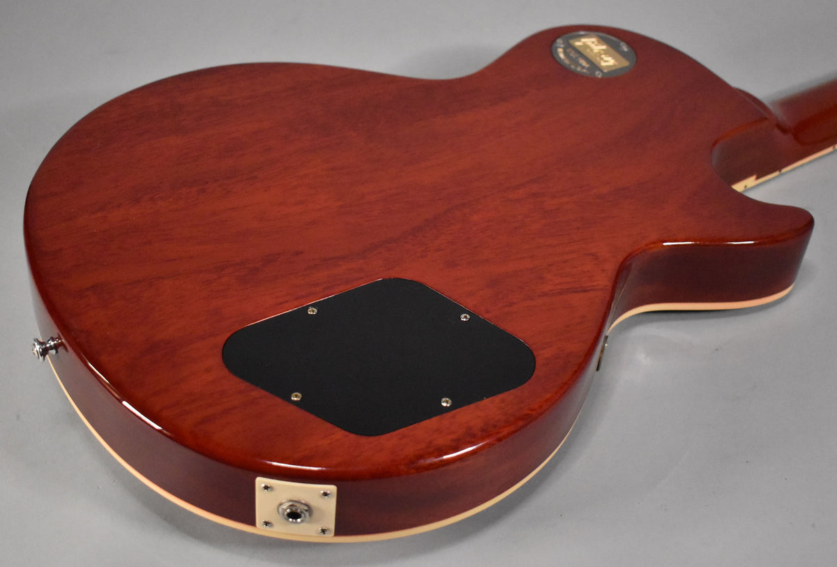 The back of the guitar shows a faded tobacco finish, a black control cavity cover, and a cream output jack plate.