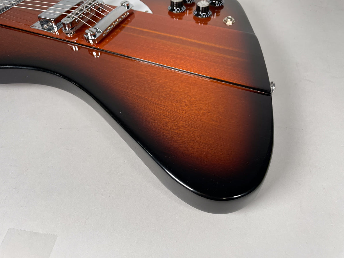 Close-up of the guitar's lower body, showing the sunburst finish fading from brown to black, with chrome bridge and controls visible.