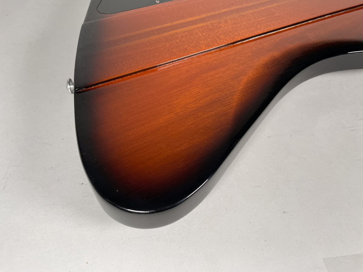 Close-up of the guitar's lower body, showing the glossy sunburst finish fading from dark brown to reddish-brown.