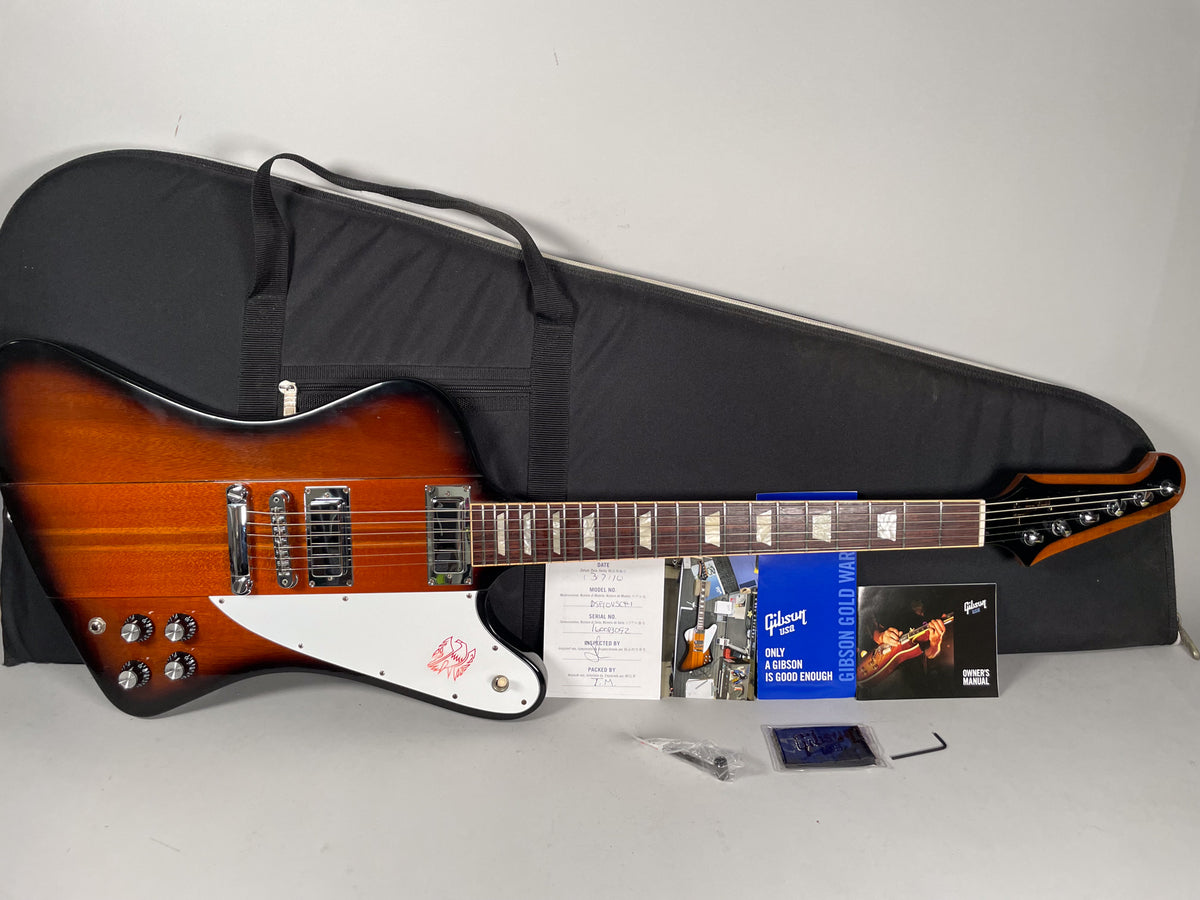 Full overhead view of a sunburst Firebird with a white pickguard, chrome hardware, and four black control knobs.