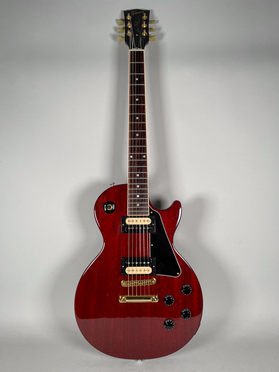Full-front view of a cherry red Les Paul Special with a glossy finish, black pickguard, gold hardware, and two humbucker pickups.