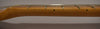 The guitar's light brown maple neck and fretboard are shown from the side, with a few frets and strings visible.
