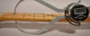 A digital caliper measures the fret height of the maple fretboard, showing 0.85mm, with light wear visible on the frets.