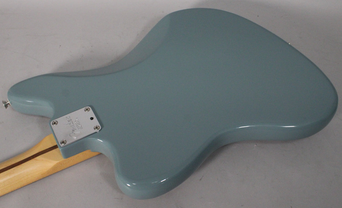 The back of the Sonic Grey Jaguar body, showing the neck plate and a light-colored maple neck with a dark stripe.