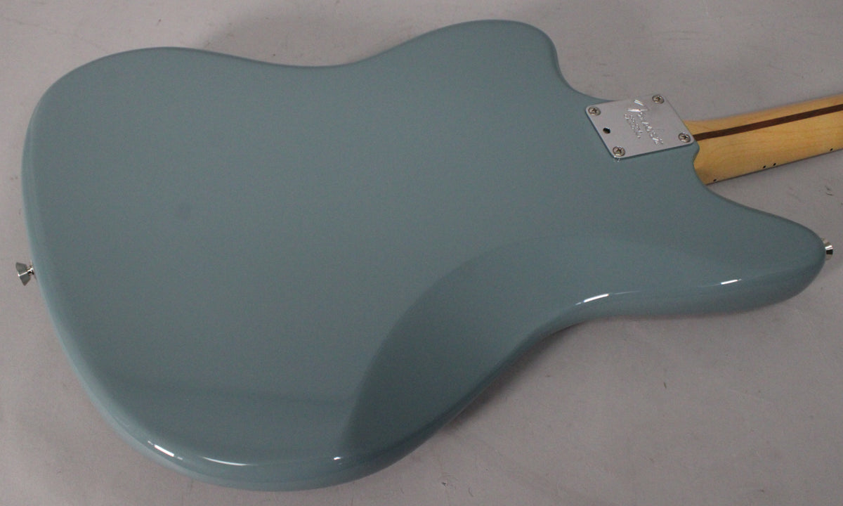 The back of a Sonic Grey Jaguar electric guitar, showing the smooth, glossy finish of the body and the neck plate.