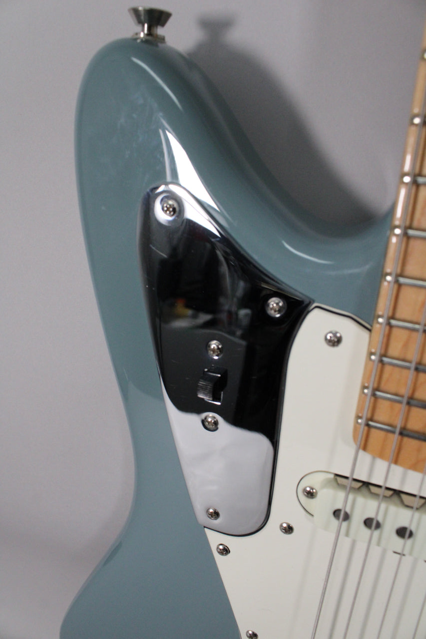 Close-up of the Sonic Grey body, showing the upper horn, chrome control plate with a black switch, and part of the white pickguard.