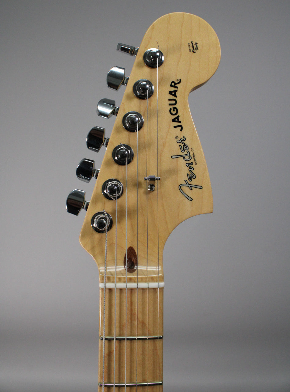 Close-up of the guitar's natural maple headstock and fretboard, showing six chrome tuners and a string tree.
