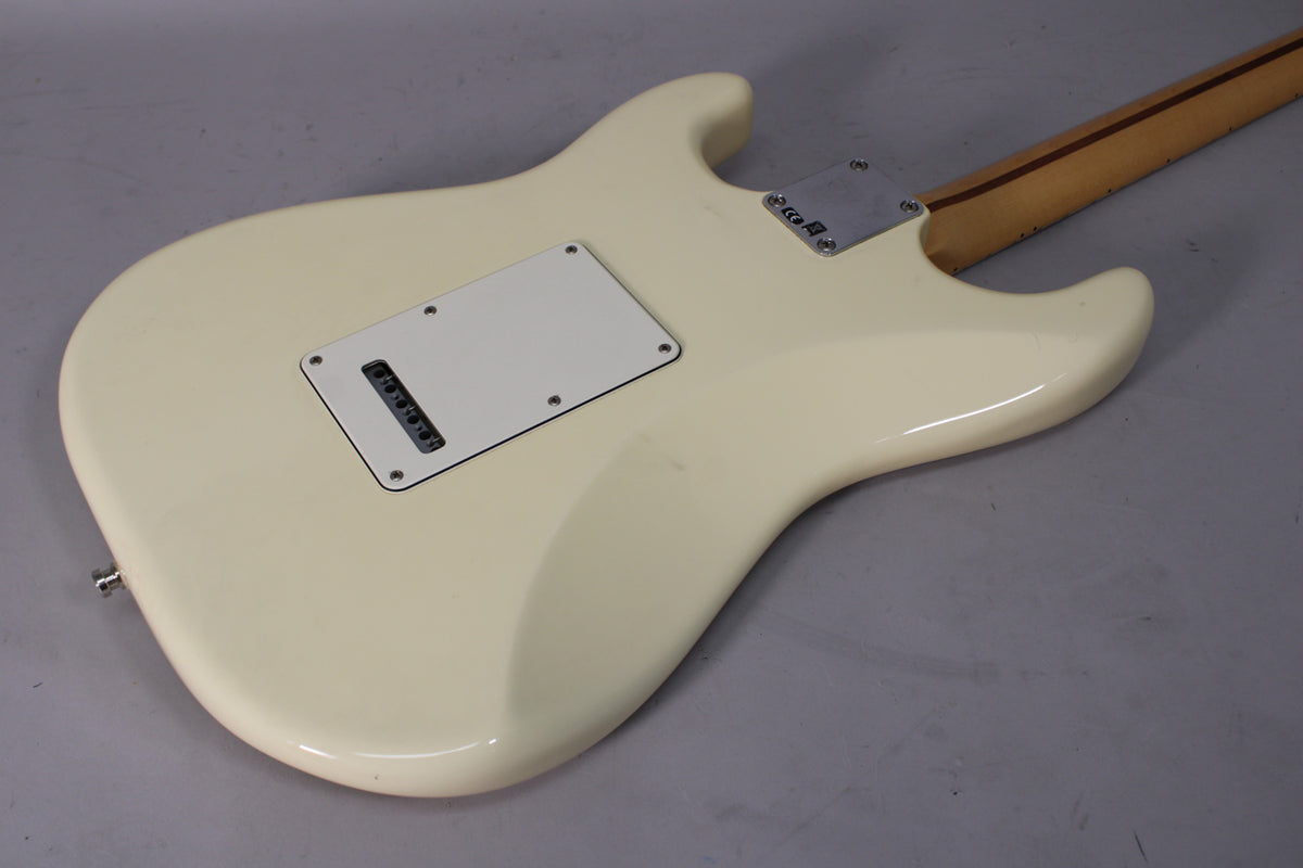 The back of an Olympic White Stratocaster body, showing the tremolo cavity cover, neck plate, and a few minor scuffs.