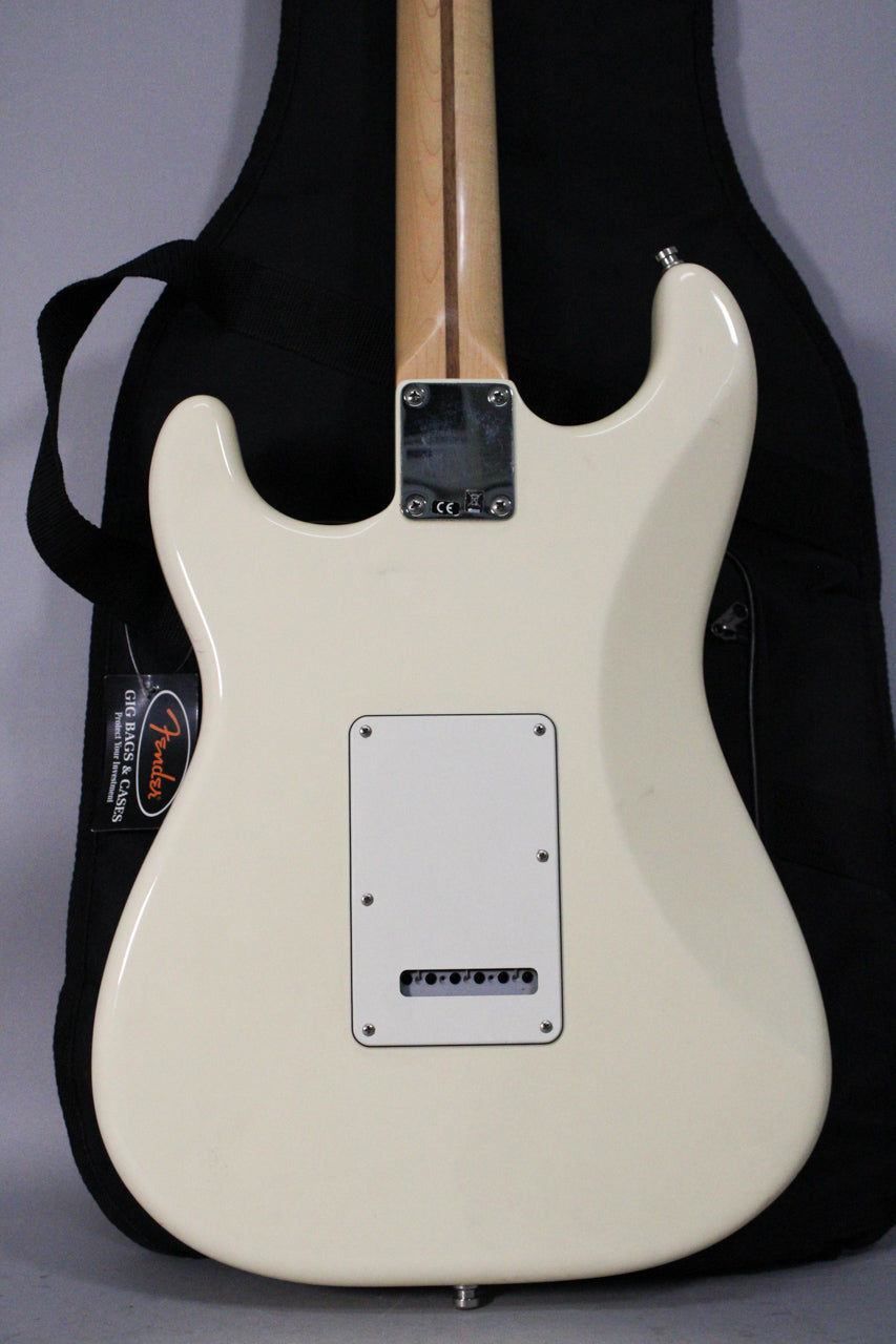 The back of an Olympic White Stratocaster, showing the neck plate, tremolo cavity cover, and string-through-body bridge.