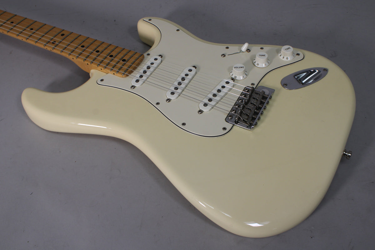 Upper body of an Olympic White Stratocaster, showing three single-coil pickups, chrome bridge, and white volume/tone knobs.