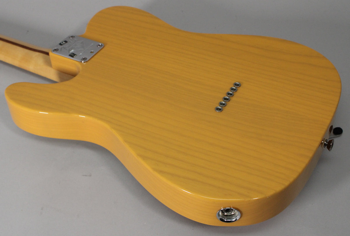 The back of the butterscotch blonde Telecaster body, showing the string ferrules, neck plate, and output jack.