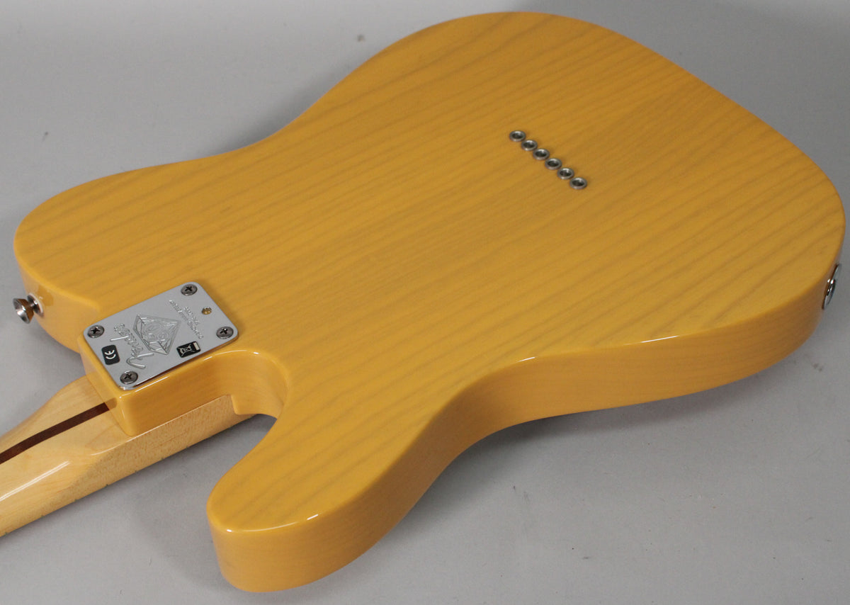The back of a butterscotch blonde Telecaster, showing the neck plate, string-through-body ferrules, and wood grain.
