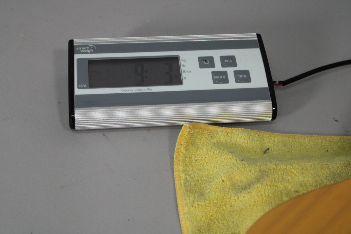 A Smart Weigh scale displays "9.3" in kg, with a yellow cloth and part of a butterscotch blonde guitar visible.
