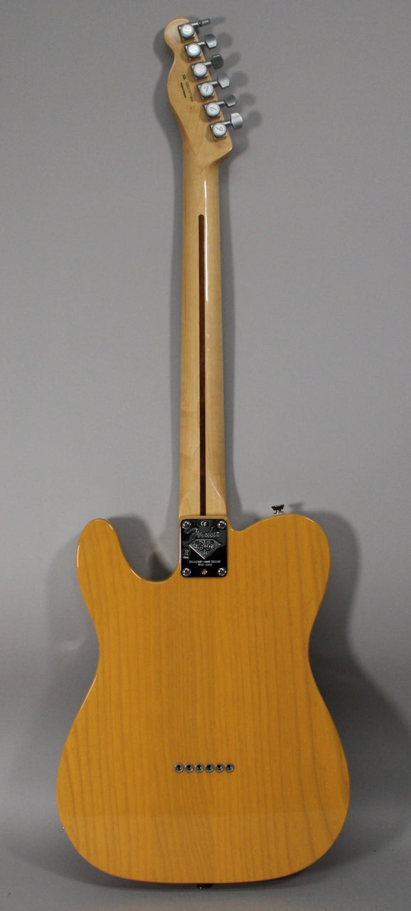 Full rear view of a butterscotch blonde Telecaster with a maple neck, chrome tuners, and string-through-body ferrules.