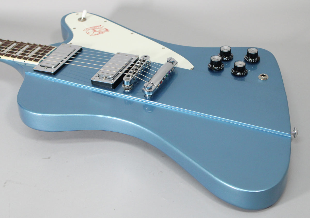 The Pelham Blue guitar body, with a white pickguard and chrome hardware, is angled from the neck to the lower bout.