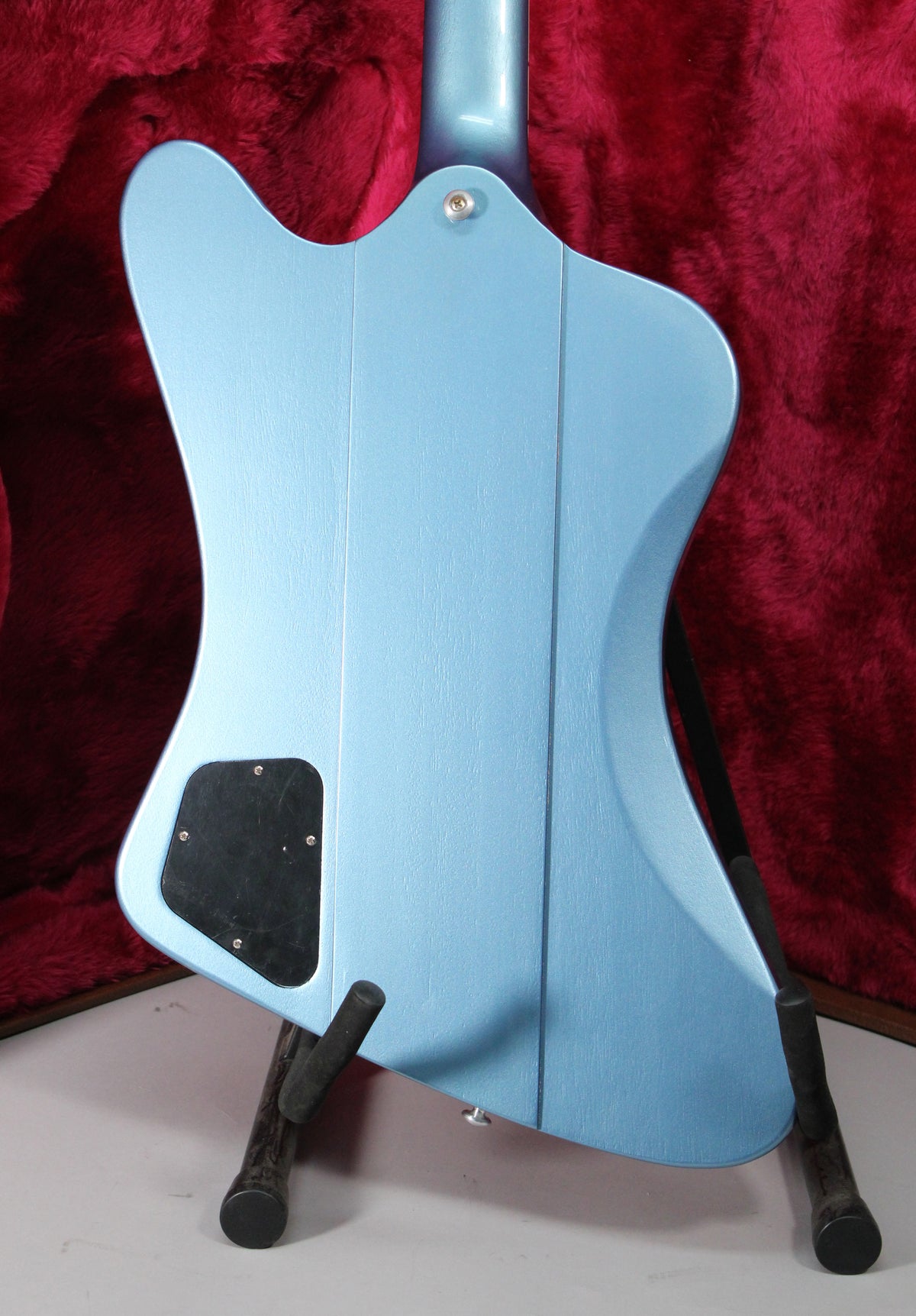 The back of a Pelham Blue Firebird, showing the neck joint, black control cavity cover, and textured finish.