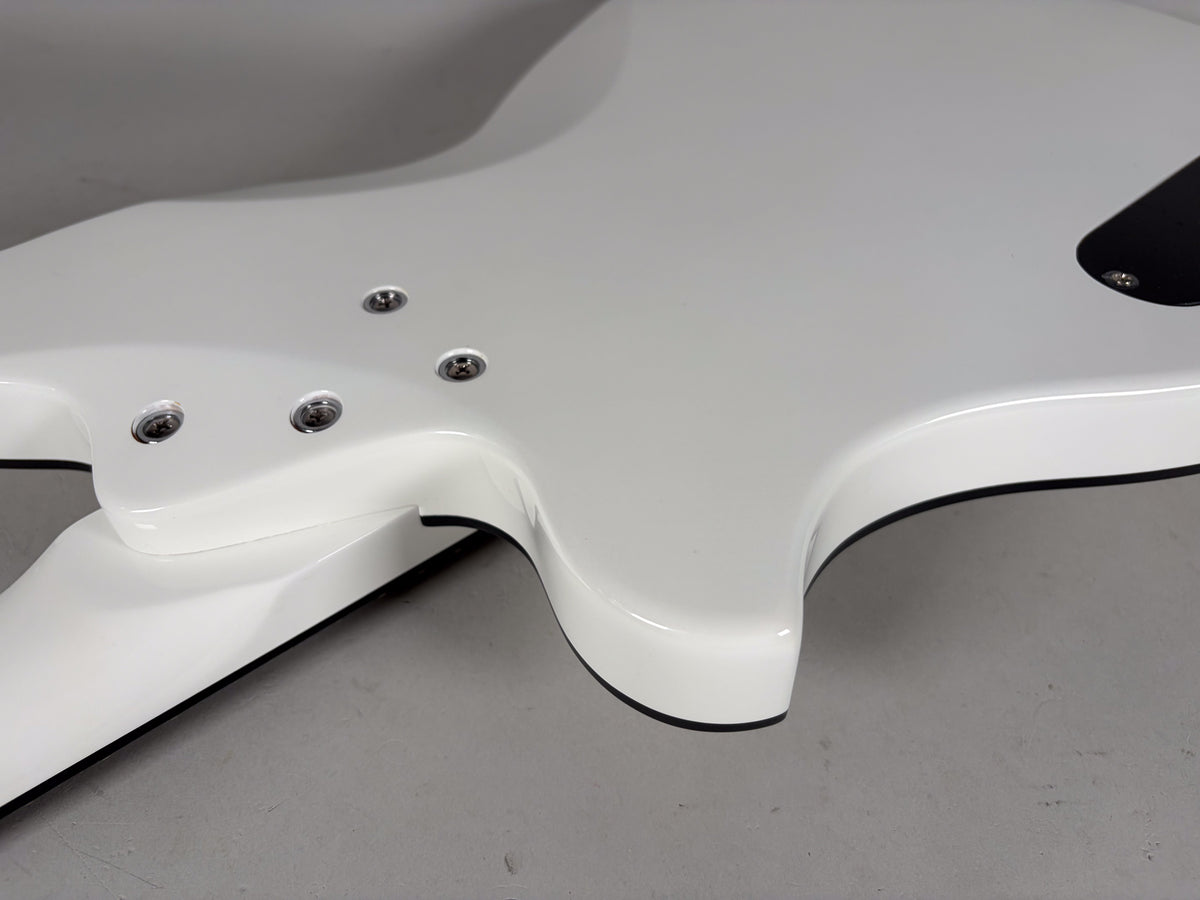 Close-up of the white guitar's body and neck joint, showing four silver neck plate screws and a smooth, glossy finish.