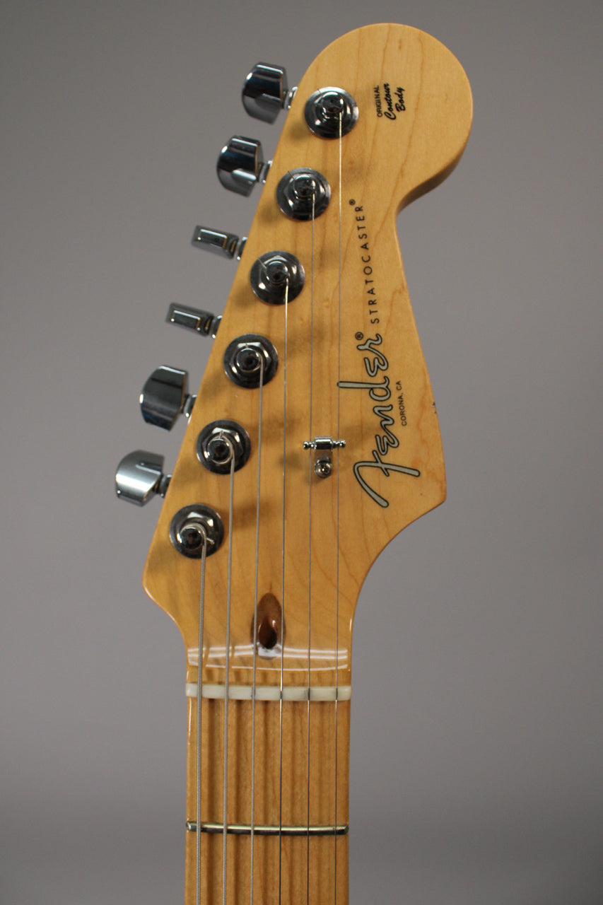 Close-up of the light wood headstock and top of the fretboard, showing six chrome tuners and a string tree.