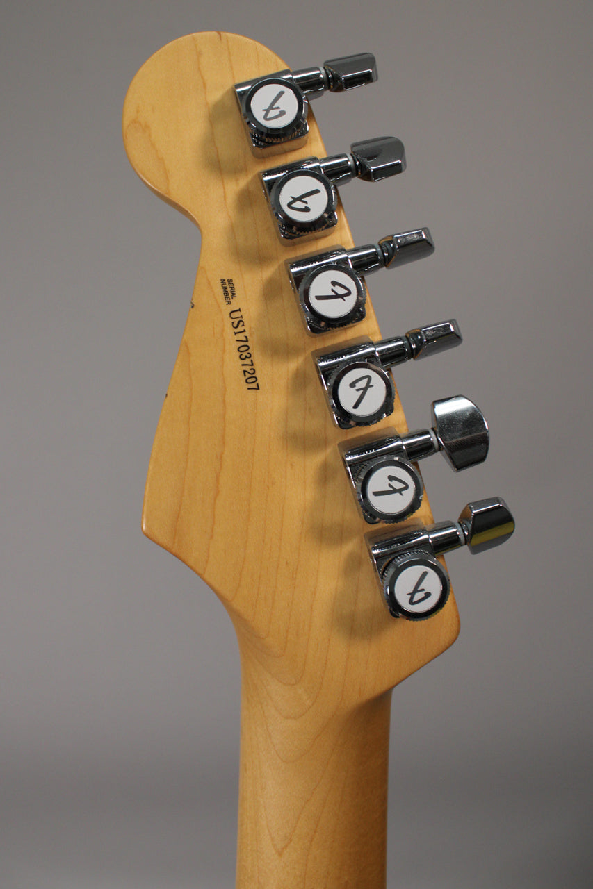 Rear view of the light-colored wooden headstock and neck, showing six chrome tuning machines with white buttons.