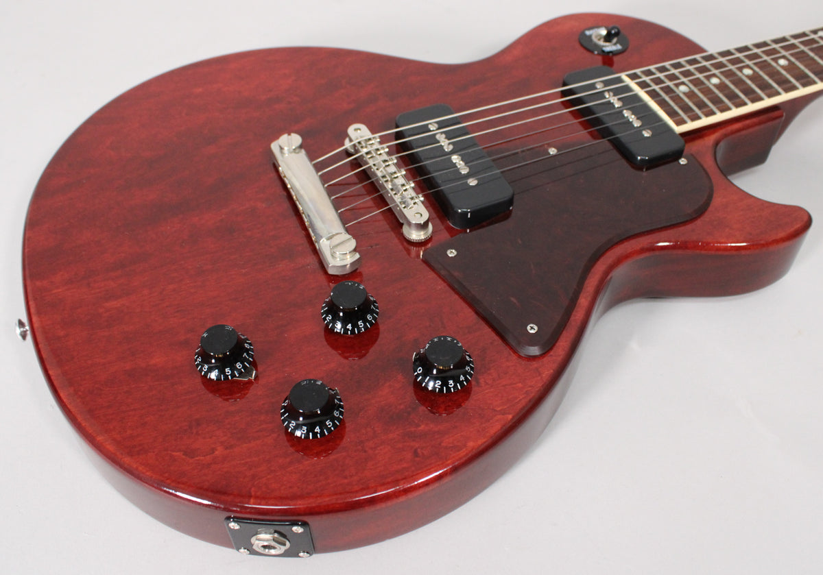 The dark cherry Les Paul Special's body, with two black P90 pickups, a dark pickguard, and four black numbered control knobs.