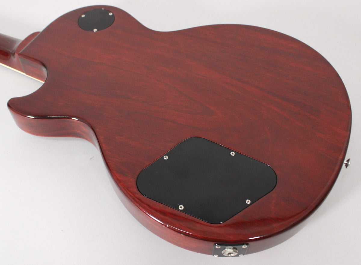 The back of a dark cherry Les Paul Special, showing the grain, two black control cavity covers, and the output jack.