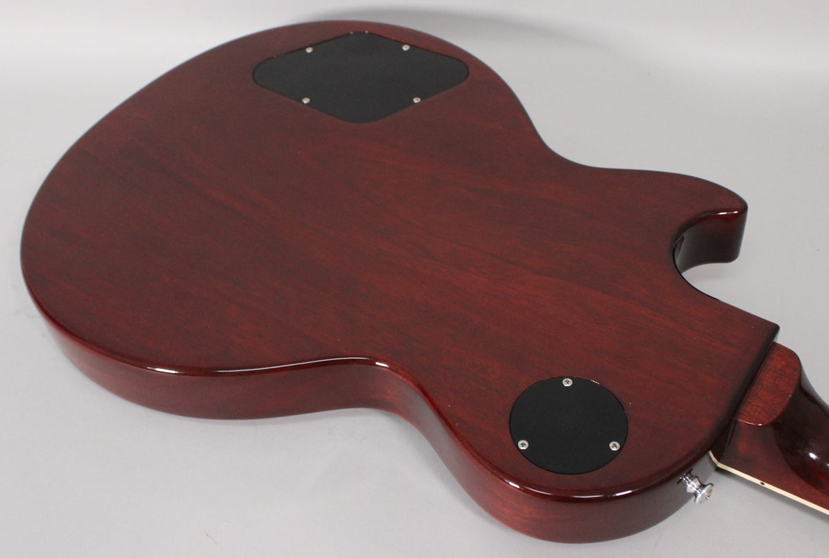 The guitar's dark cherry back has a glossy finish, with two black control cavity covers and a chrome strap button visible.