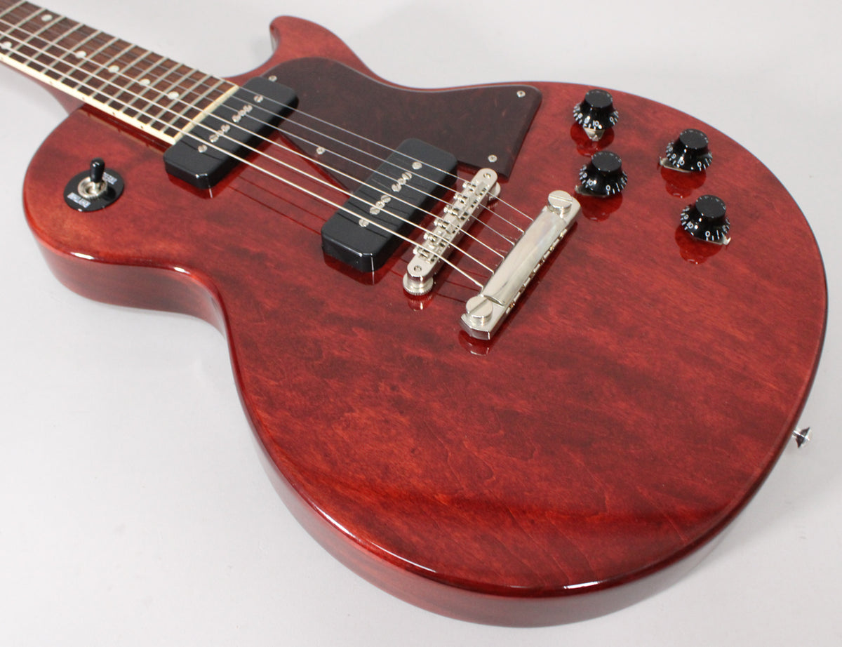 The dark cherry Les Paul Special body is angled, showing the two P90 pickups, tune-o-matic bridge, and four black control knobs.