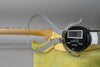 A digital caliper measures the neck thickness at the first fret of the vintage white Telecaster, showing 0.90 on the display.