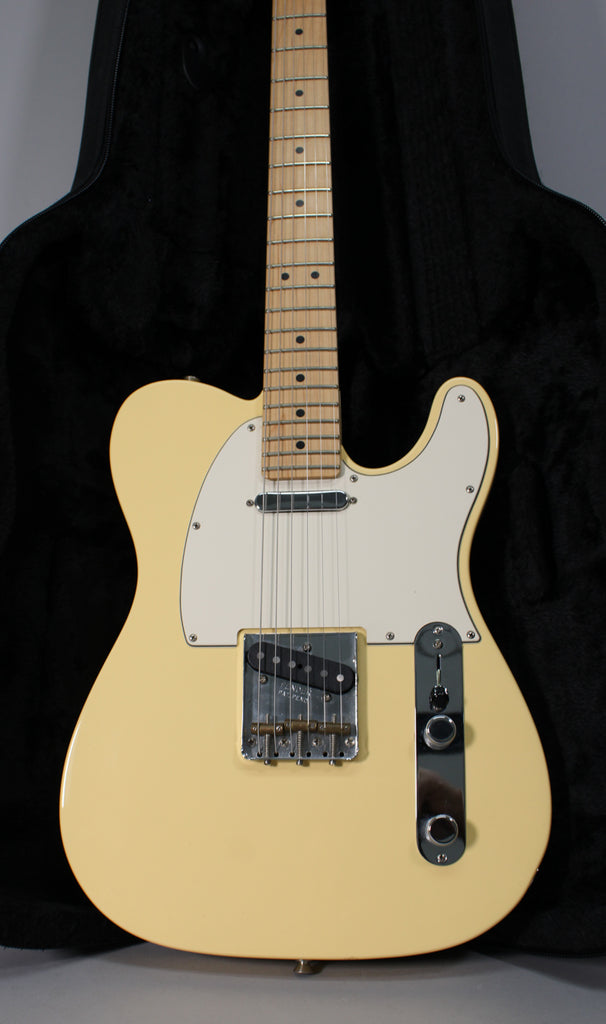Full-frame, top-down view of a vintage white Telecaster with a maple neck, white pickguard, and chrome hardware.