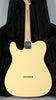 The back of a vintage white Telecaster, showing the light maple neck, chrome neck plate, and six string-through-body ferrules.
