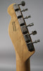 Rear view of the natural maple headstock and neck, showing six chrome tuners with ribbed casings and trapezoidal buttons.