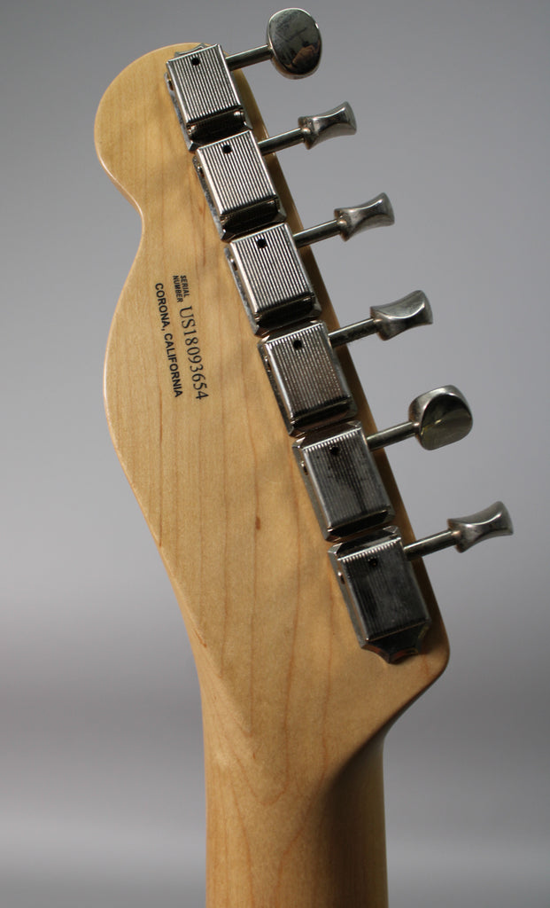 Rear view of the natural maple headstock and neck, showing six chrome tuners with ribbed casings and trapezoidal buttons.