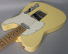 Vintage white Telecaster body, angled from the lower bout, showing a maple fretboard, white pickguard, and chrome hardware.