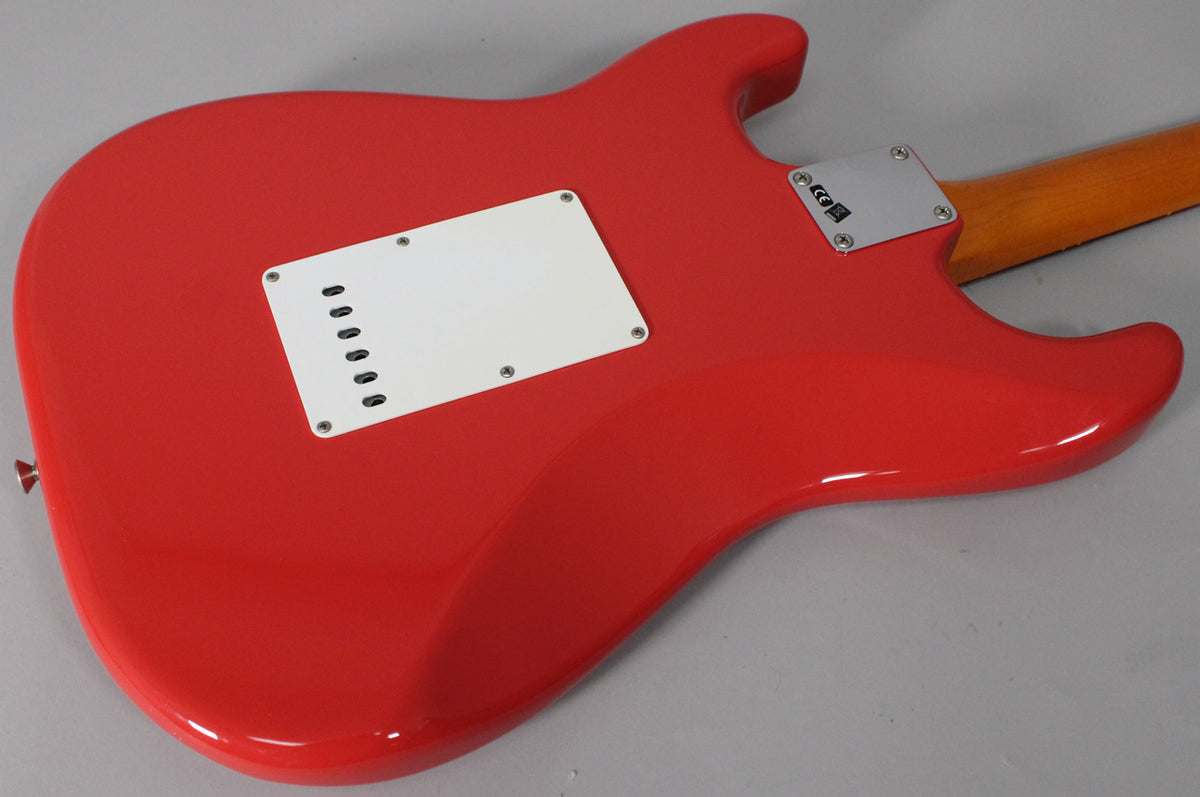 The back of a glossy Fiesta Red Stratocaster, showing the white tremolo cover, chrome neck plate, and a hint of the wooden neck.